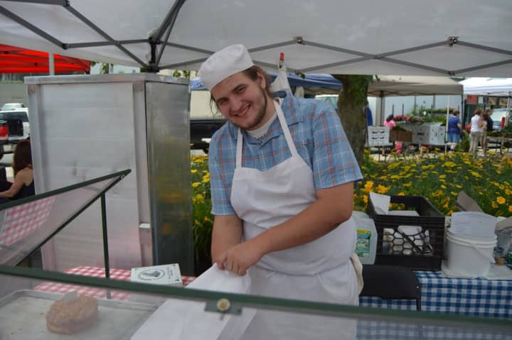 Alessandro Dipierro from Brewster Pastry bags up some goodies at the Danbury Farmers Market. 