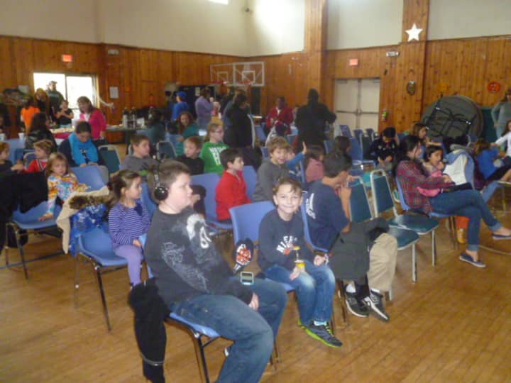Dobbs Ferry children watch a movie screened by the Recreation Department and Police Benevolent Association Thursday at the Embassy Community Center.