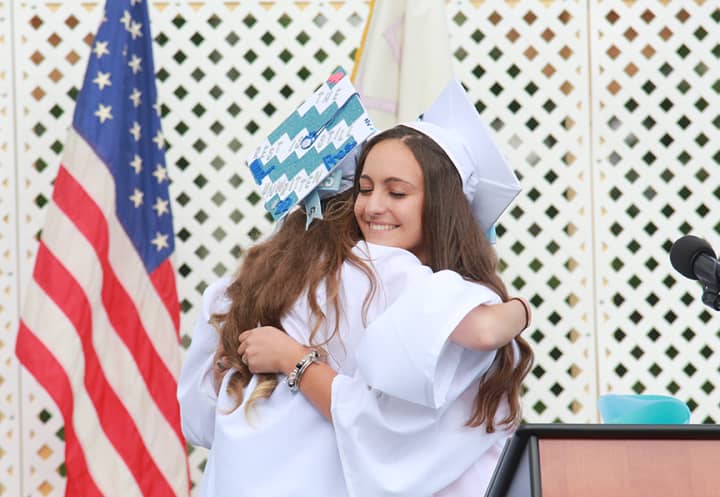 Westlake HIgh School senior Lexi Pichiarallo hugs Class of 2015 President Samantha Howard at Friday&#x27;s commencement exercises.
