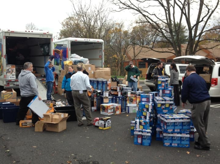 Volunteers from Louisville, Ky., hand out supplies at Atria On The Hudson in Ossining on Wednesday. 