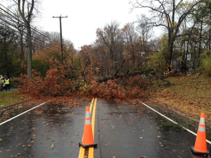 A downed tree causes one of the road blockages in Weston that is impeding CL&amp;P power restoration efforts.
