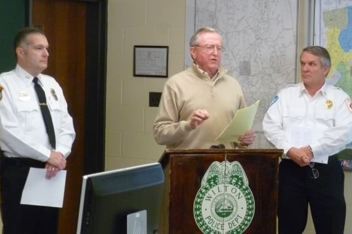 Wilton First Selectman Bill Brennan, center, speaks during a news conference on the town&#x27;s power recovery efforts on Friday. Flanking him are Police Chief Michael Lombardo, left, and Fire Chief Paul Milositz. 
