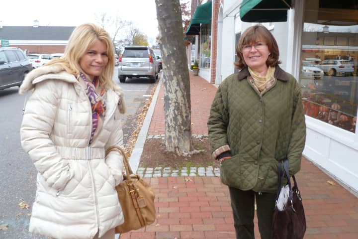 Friends Adriana DeGabriel, left, of Stamford and Yvonne Hunkeler of New Canaan met up in Downtown New Canaan on Friday. Both of their homes are without power since Hurricane Sandy. 