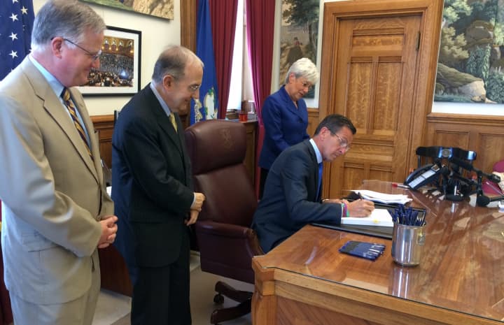 Gov. Dannel Malloy signs the Connecticut budget on Tuesday afternoon. 