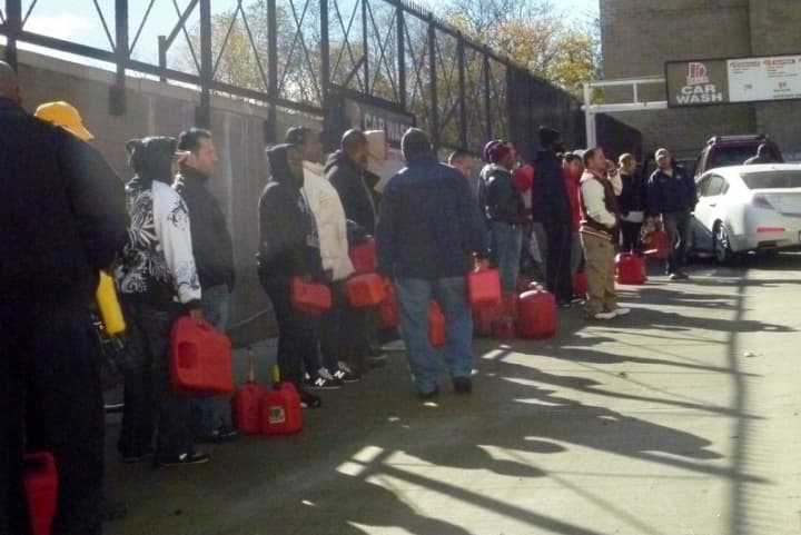 People wait to fill up gas cans at a station in Yonkers on Saturday.
