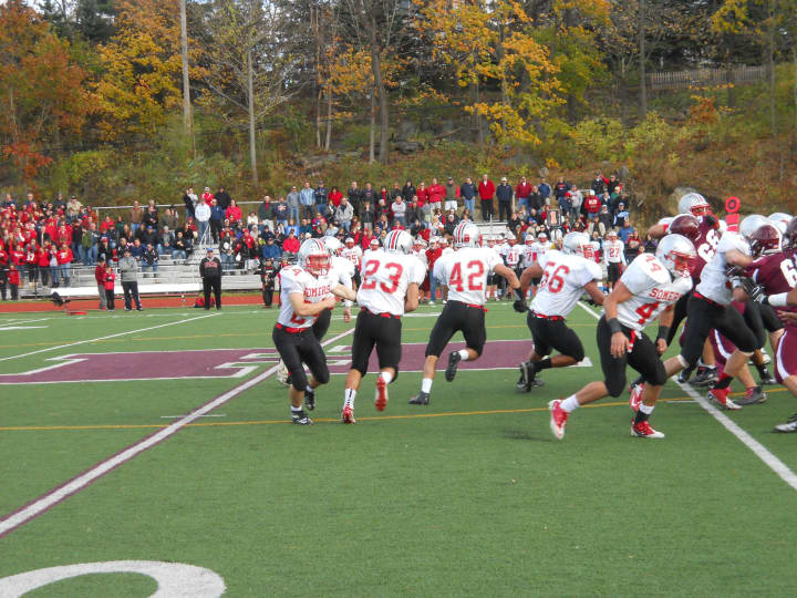 Stefano Bicknese (#23) takes a handoff and follows his blockers in Somers&#x27; 28-14 win over Harrison in a Section 1 Class A Football Championship semifinal Saturday.