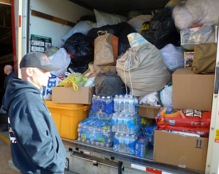 Yonkers firefighter Tim Sullivan stands in front of a U-Haul truck packed with donations bound for Hurricane Sandy victims in Queens. 