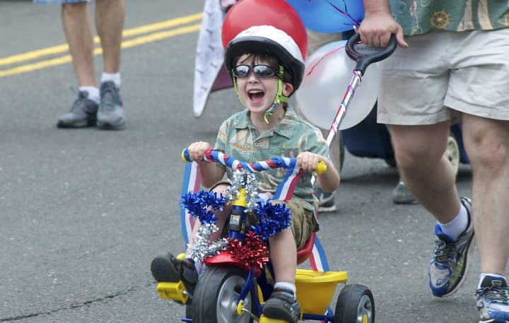 A young boy is thrilled to be part of the Push-n-Pull Parade in Darien.