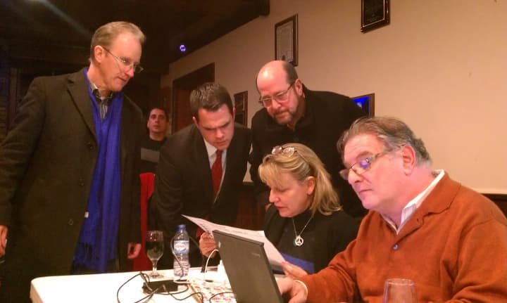 David Carlucci, with volunteers and Ossining officials, look over early results from Ossining on Tuesday night.