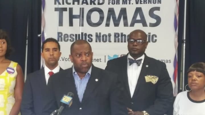 Pastor Stephen Pogue of the Greater Centennial A.M.E. Zion Church speaking on behalf of mayoral candidate Richard Thomas (left) about violence in the city.
