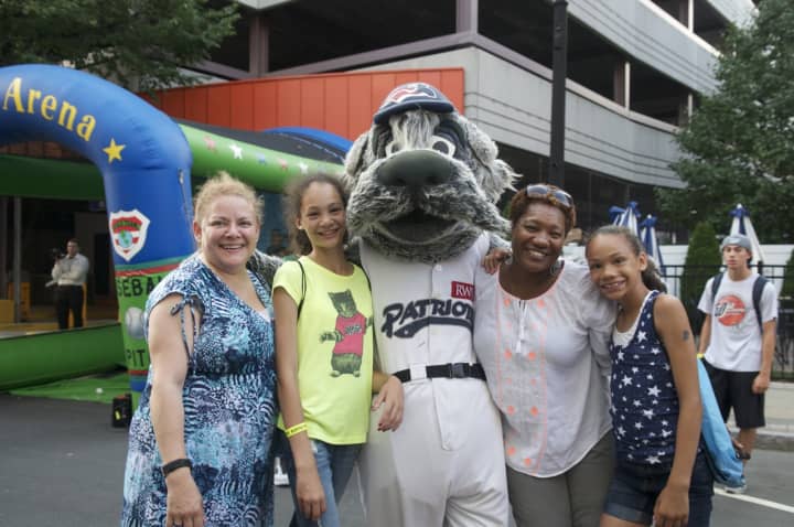 Fans pose with one of the mascots at Tuesday&#x27;s block party.