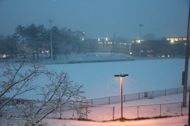 The Mamaroneck High School football field gets covered in snow Wednesday night. 