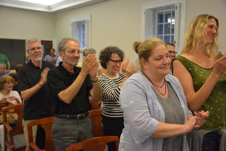 Several attendees give standing ovations after the Bedford Town Board approved lowering a cap on first-floor storefronts in the town&#x27;s hamlet centers.