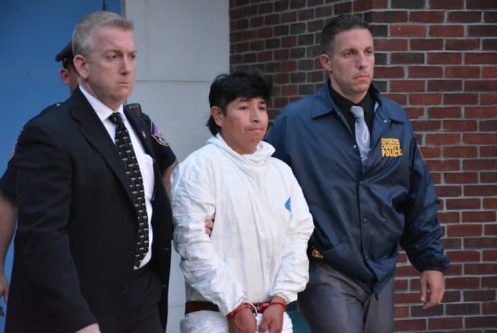 Manslaughter suspect Milton Ventura (center), is escorted from Mount Kisco Justice Court following his arraignment. 