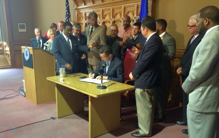 Gov. Dannel P. Malloy signs the Second Chance Society legislation into law on Thursday in Hartford. 