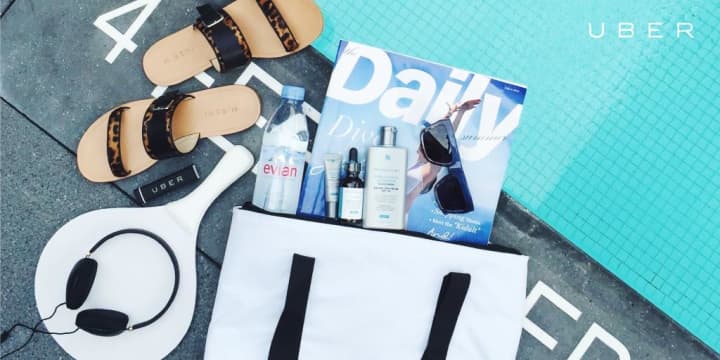 The Uber bag appears to be filled with sandals, headphones, a magazine, sunscreen and more. 