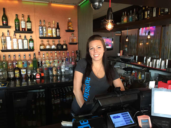 Flipside Burgers and Bar Manager Lindsay Oakes poses behind the bar.
