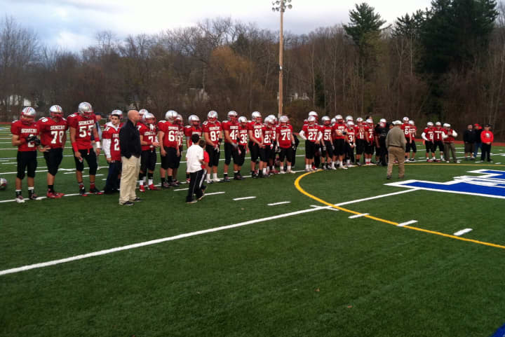 The Somers High School football team watches Cornwall receive a plaque for winning Monday&#x27;s state quarterfinal game.