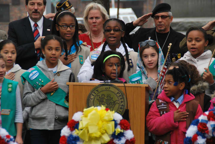 Peekskill Girl Scouts lead the Pledge of Allegiance.