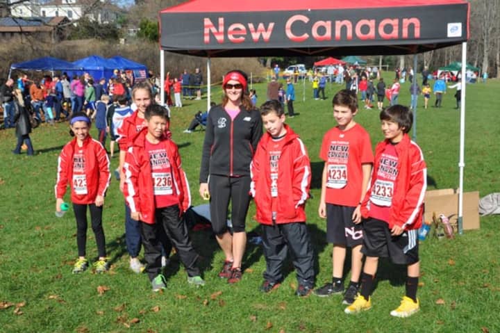 New Canaan runners (left to right) Dixie DAmelio, Cali Brannan, Dylan Wiedtfeldt, Christian Meier, Christopher Carratu and  Henry Asker stand with coach Alexandra Portonova.