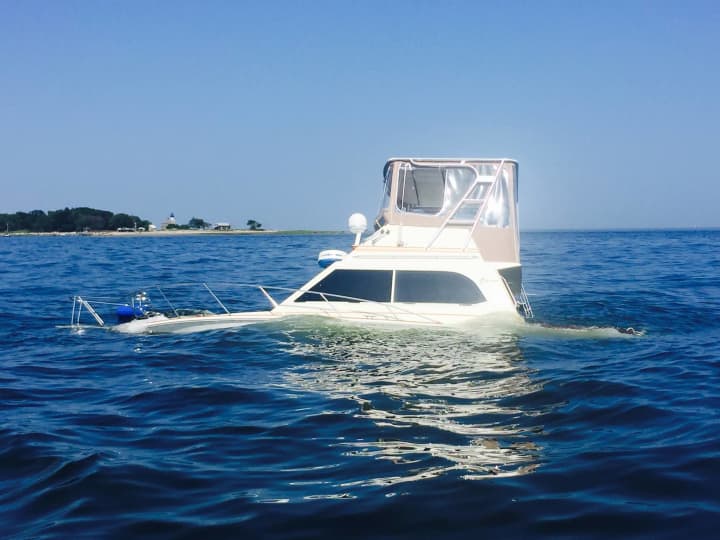 The boat remains partially submerged in Long Island Sound off Norwalk.