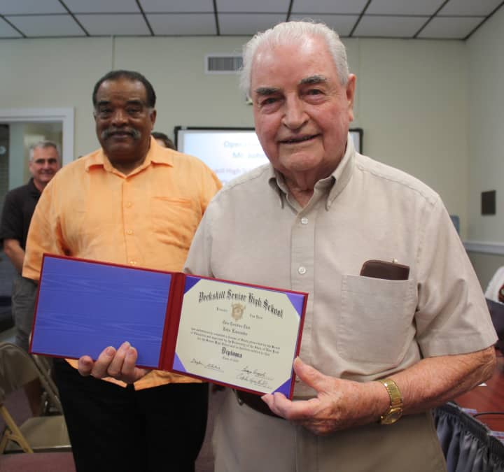John &quot;Jack&quot; Lancaster displays his high school diploma July 7 after ceremonies at the Peekskill Board of Education meeting as friend Jim Taylor, left, watches.