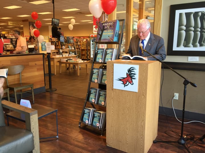First Selectman Michael Tetreau reads &quot;Go Set a Watchman&quot; during a live reading at the Fairfield University Bookstore Tuesday. 