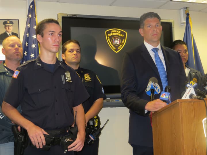 Greenburgh Police Officer Peter Schmidt Jr., front left, drew praise from Chief Chris McNerney, right, during a Tuesday news conference for helping catch two suspects charged with trying to murder Schmidt&#x27;s father in Elmsford on Monday.