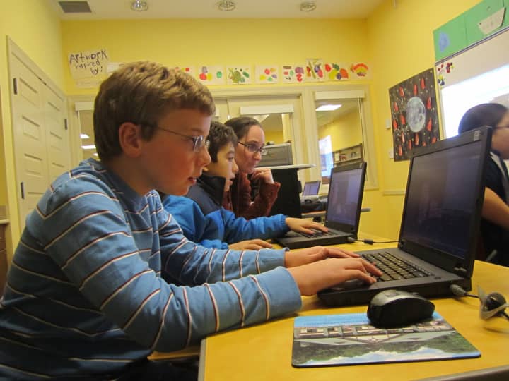 Andrew Vancamp, 11, creates his own video game while Amy Kaplan assists Caleb Schumacher, 11, at the Briarcliff Manor Public Library. 