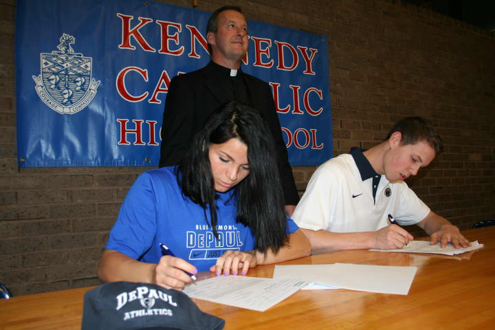 The Rev. Mark Vaillancourt, Kennedy&#x27;s president and principal, looks on as Rachel Entwistle and Schuyler Bates sign with DePaul and Penn State, respectively, on the first day of the 2012 signing period.