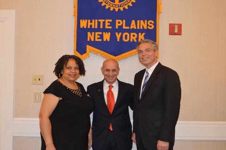 Heather Miller, left, the outgoing President, and White Plains Mayor Tom Roach, right, welcome L. William Fishman as the new president of the Rotary Club of White Plains.