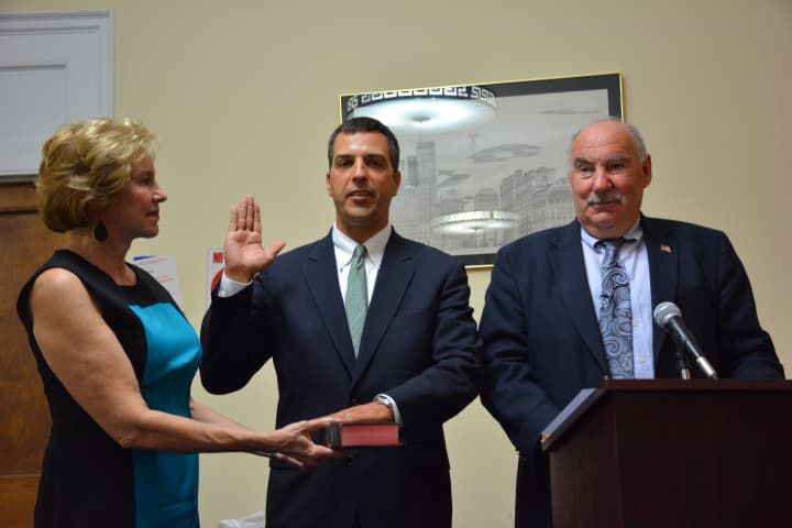 Edward Brancati (center) is sworn in as Mount Kisco Village Manager, with Mayor Michael Cindrich (right) giving the oath. 