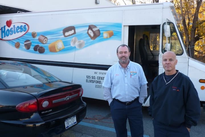 Delivery drivers Lou Maresco, left, and Chris Shiaffarelli stand in front of a Hostess Brands truck at the company&#x27;s Elmsford bakery outlet. Hostess Brands announced Friday that it is going out of business.