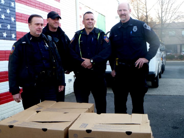 From left: Officers Peter McManus, Erik Soderholm and John O&#x27;Meara and Lt. Mike Noto drop off gobblers to the Food Bank of Lower Fairfield County. 