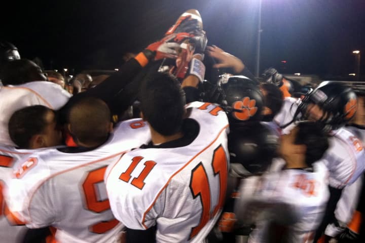 The Tuckahoe Tigers football team celebrates its win Friday to advance to the state finals in Syracuse.