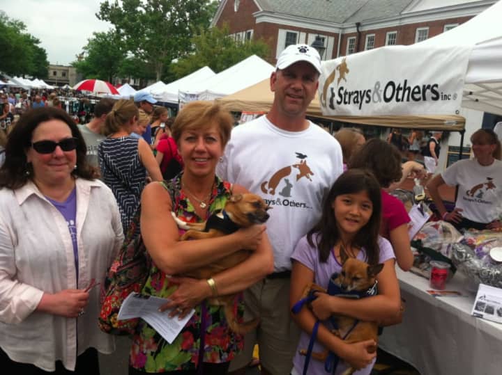 From left: Claudia Weber, Lia Toth with &#x27;Peewee,&#x27; Claude Colabella, and Charlotte Frank holding &#x27;Pookie&quot; outside the Strays &amp; Others tent at the New Canaan sidewalk sale Saturday.