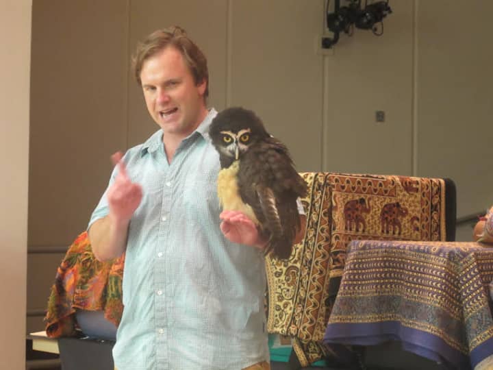 A spectacled owl visits the library as a part of Animal Embassy.