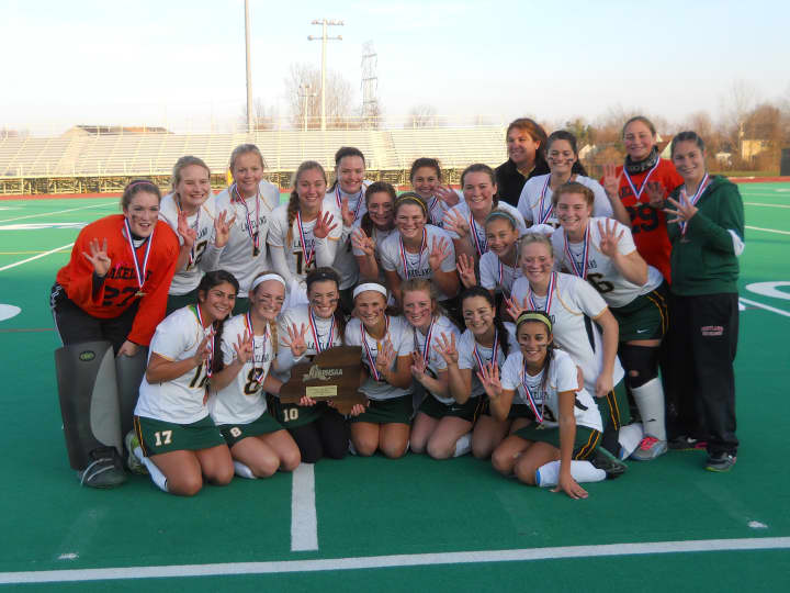 The Lakeland varsity field hockey team holds up four fingers after winning their fourth consecutive New York State Class B field hockey championship Saturday. Lakeland beat Pittsford Sutherland, 6-0.