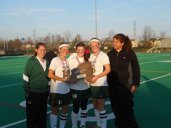 Lakeland captains, from left, Gianna Bensaia, Rebeeca Bard and Kristen Conroy with assistant coach Jenna Wenkl, left, and coach Sharon Sarsen, right. The captains played on the four consecutive Lakeland state-champion teams from 2009-12.