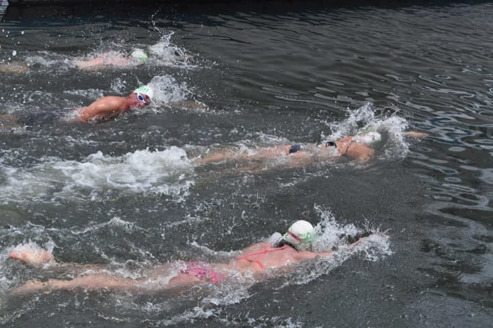 Swimmers compete in the Swim Across The Sound last year.