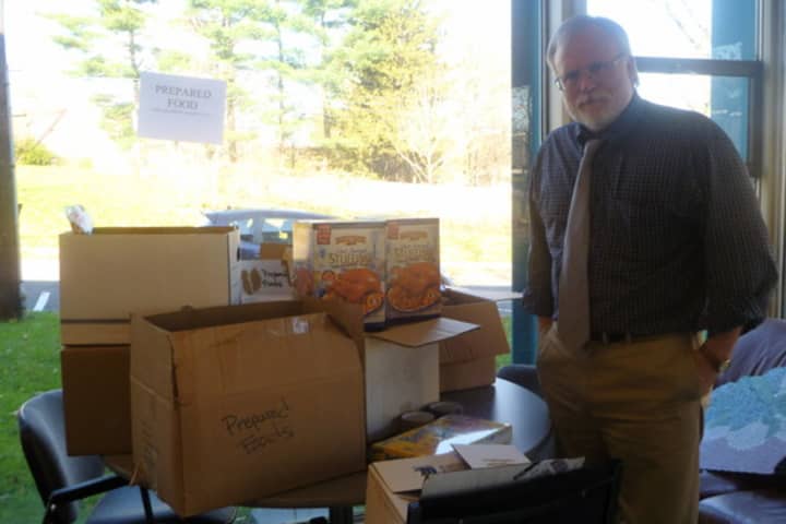 Paul Anderson-Winchell, executive director of the Grace Church Community Center in White Plains, with food donations being sorted for Thanksgiving deliveries.