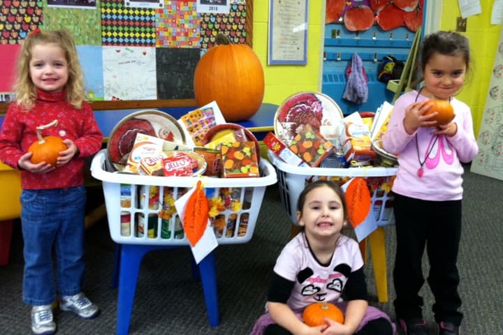 The students at Gray Farms Nursery School in Stamford put together baskets of food so families in need can have a Thanksgiving meal. 