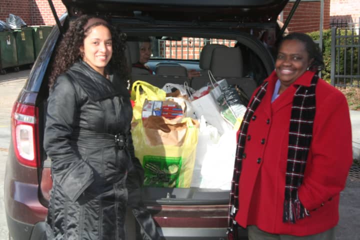 Carmen Diaz and Almarie Fridovich, social workers at Albert Leonard Middle School deliver food to 10 needy families in New Rochelle. Albert Leonard families, faculty, and staff donated the food.