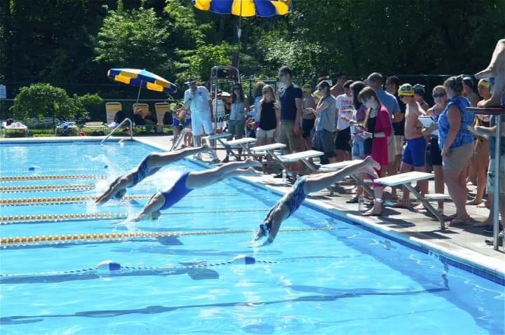 Swimmers dive in to start a race at the Chappaqua Swim &amp; Tennis Club.