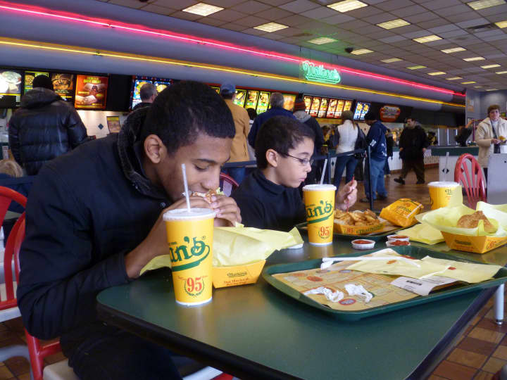 Yonkers&#x27; Ricardo Fortuna and his brother, Omar, enjoy a meal at Nathan&#x27;s Famous Hot Dogs Sunday, the final day the restaurant was open. 