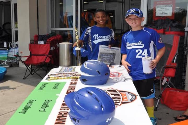 Norwalk Cal Ripken 11-year-old All-Stars Jayden Gonzalez and Jake Palmer man the table outside Sports Authority.