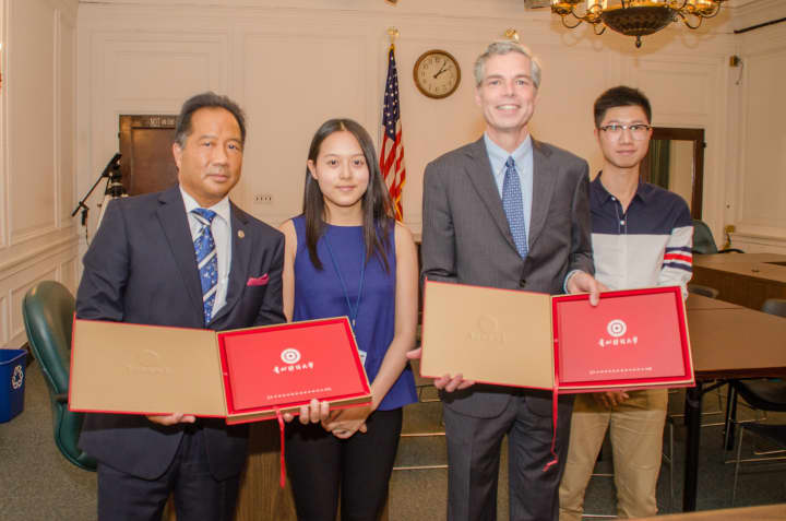 White Plains Mayor Thomas Roach and White Plains Safety Commissioner David Chong received gifts from Chenglin Zhang (second from left) and Chang Liu (right) who represent the student delegation from Guizhou Province in China.