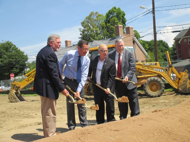 CIFC board chair Frank Muska, Gov. Dannel Malloy, Mayor Mark Boughton and CIFC President James Maloney turn over a ceremonial shovel full of dirt at the groundbreaking of a new Community Health Center on Main Street in Danbury. 