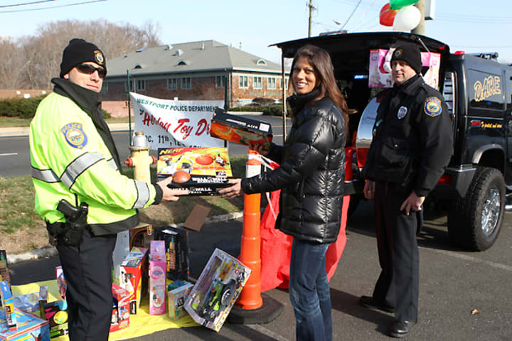 Westport police collect donated toys during a past year&#x27;s holiday toy drive. This year&#x27;s toy drive will be held Dec. 8, 9, 15 and 16 outside the Athletic Shoe Factory, 1560 Post Road E.