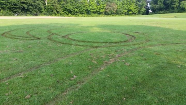 The Ridgefield Police Department charged two men with damage done to the playing fields at East Ridge Middle School.